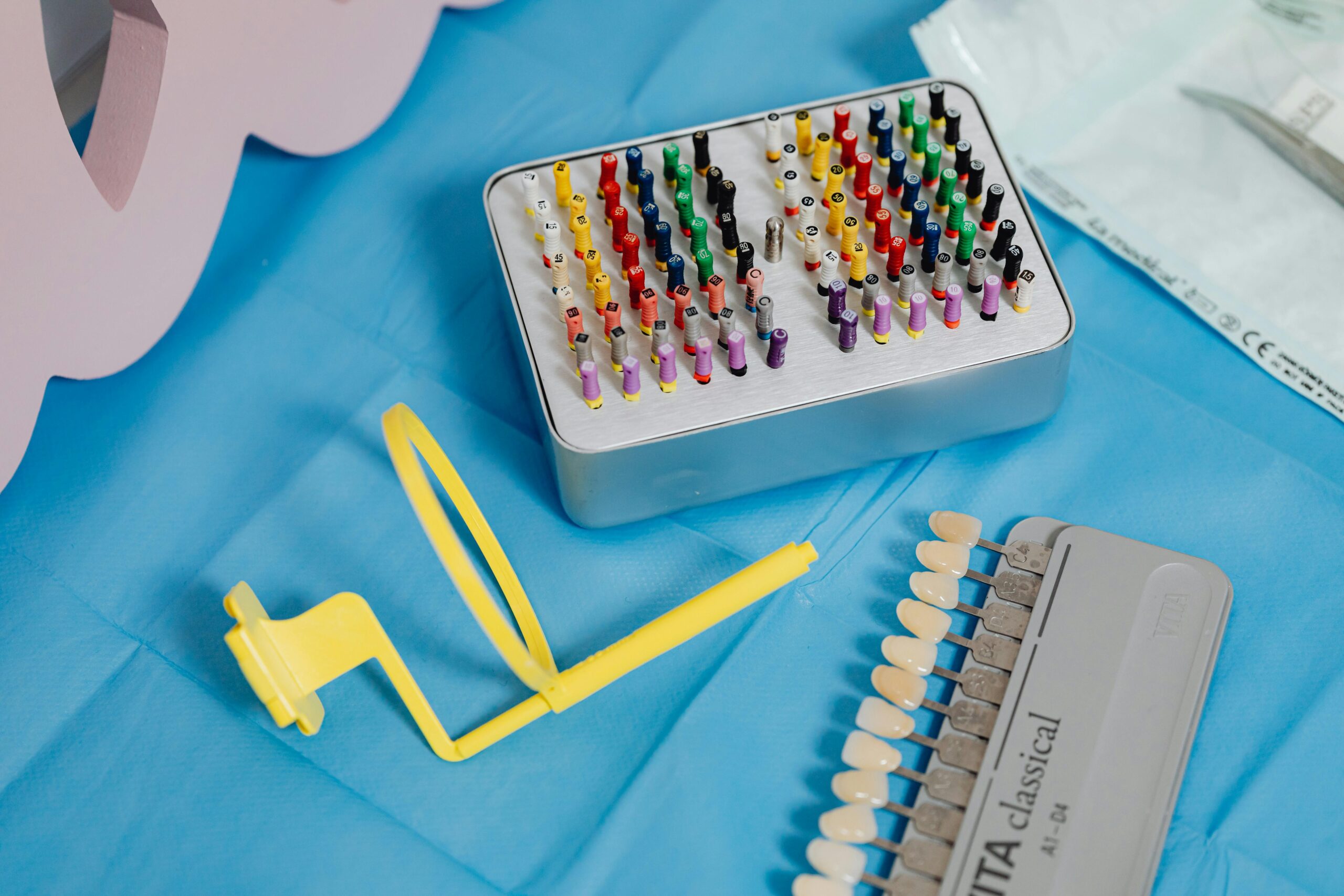 A vibrant collection of dental tools displayed on a sterile blue cloth ready for dental use.